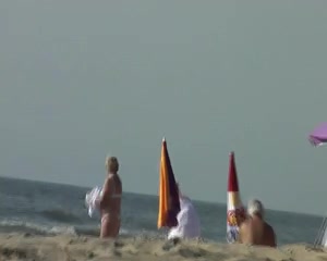 Voyeur watching a large-boobed mother I'd like to fuck on a beach