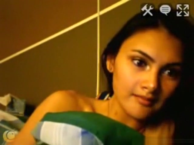 Dark haired girl masturbates with a hairbrush on her bed