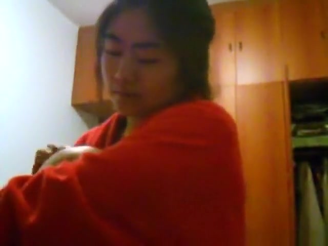 Asian girl with big boobs changes clothes in her bedroom
