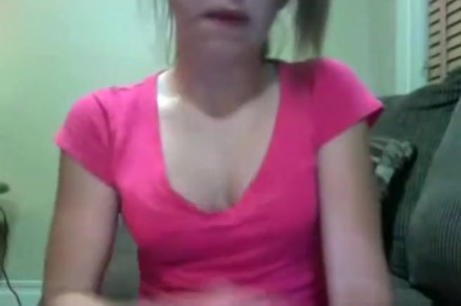 Brunette girl teases naked and fingers her shaved pussy closeup on her bed