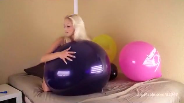 Blond girl bounce some big balloons